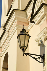 Image showing Metal illuminator on ancient wall of  building.