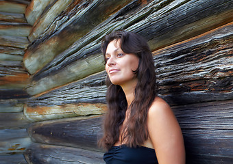 Image showing Beautiful girl near the wooden wall