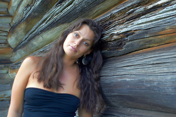 Image showing Beautiful girl near the wooden wall