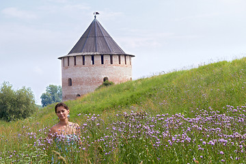 Image showing Woman in field on castle background