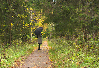 Image showing women vaiting long alley at fall autumn season