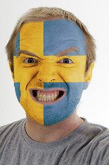 Image showing Face of crazy angry man painted in colors of Sweden flag