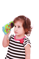 Image showing Smiling cute little girl in dress calling by telephone