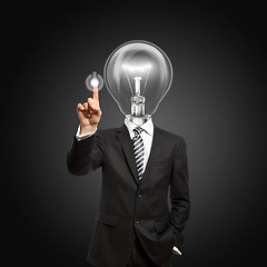 Image showing businessman with lamp-head push the button