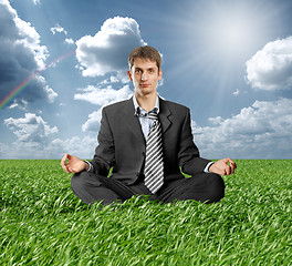 Image showing businessman in lotus pose outdoors