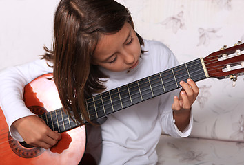 Image showing Young girl play classical guitar 