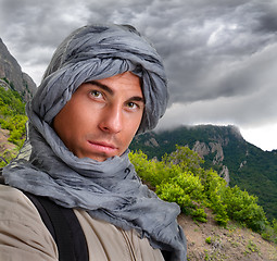 Image showing tourist hiding his head under a shawl