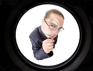 Image showing businessman looking through magnifying glass