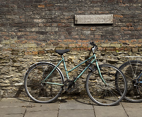 Image showing Bicycle leaning against brick wall