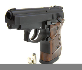 Image showing The close up of a pistol a target and cartridges is isolated on 