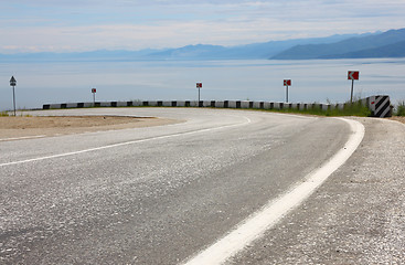 Image showing Asphalt road and sky with clouds