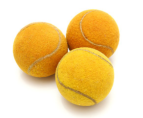 Image showing Three old tennis balls on a white background