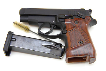 Image showing The close up of a pistol a target and cartridges is isolated on 