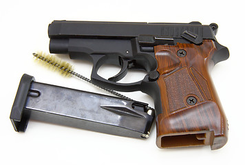 Image showing The close up of a pistol a target and cartridges is isolated on 