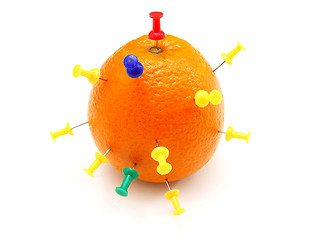 Image showing Isolated colourful office pins thrust in an orange