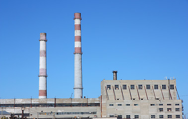 Image showing chimneys  large plant against the blue sky