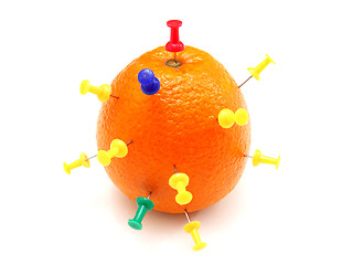 Image showing Isolated colourful office pins thrust in an orange