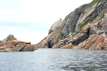 Image showing Rocks in the blue sea, illuminated by the sun. Background.