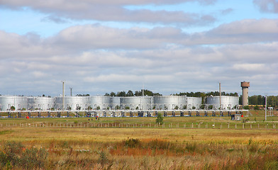 Image showing white tanks in tank farm with clouds in sky