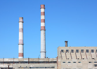 Image showing chimneys  large plant against the blue sky