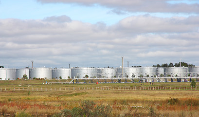 Image showing white tanks in tank farm with clouds in sky