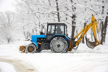 Image showing Tractor removes snow in a park