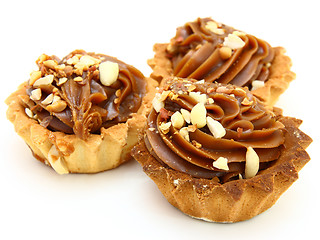 Image showing Pie a basket with chocolate condensed milk and nuts