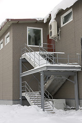 Image showing Ladder in snow on the second floor with windows