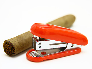 Image showing Red stapler and cigar 