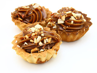 Image showing Pie a basket with chocolate condensed milk and nuts 