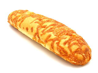 Image showing The ruddy long loaf of bread is strewed by cheese 