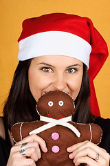 Image showing Santa Claus girl with gingerbread man puppet