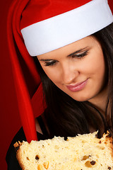 Image showing Santa Claus girl eating panettone