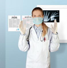 Image showing doctor woman in mask looking at camera