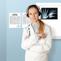 Image showing doctor woman with headphones smile at camera