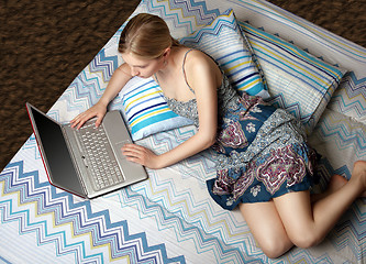 Image showing girl with laptop on the bed