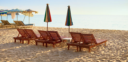 Image showing Group of wooden sunbeds on beach