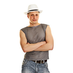 Image showing A young man in a T-shirt, jeans and a hat