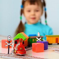 Image showing Little girl with toy railroad