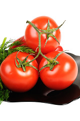 Image showing Tomatoes on a black plate