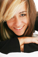 Image showing happy beautiful woman lies on a pillow in the bedroom, beautiful