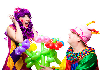 Image showing loving clowns with colorful flowers