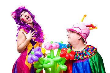 Image showing loving clowns with colorful flowers