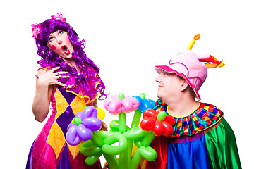 Image showing loving clowns with colorful flowers