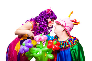 Image showing loving clowns with colorful flowers