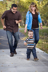 Image showing Happy Mixed Race Ethnic Family Walking In The Park