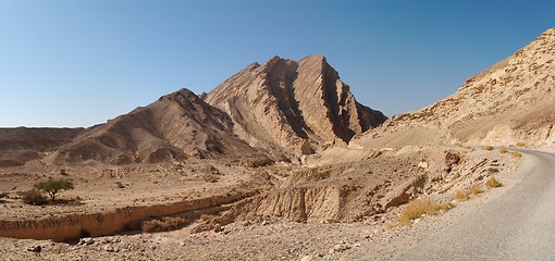 Image showing Scenic ridged brown rock at the road  in stone desert