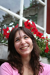 Image showing Smiling girl among flowers