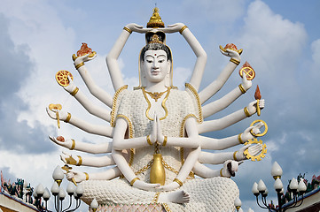 Image showing Eighteen arms Buddha over blue sky