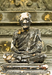 Image showing weathered monk statue